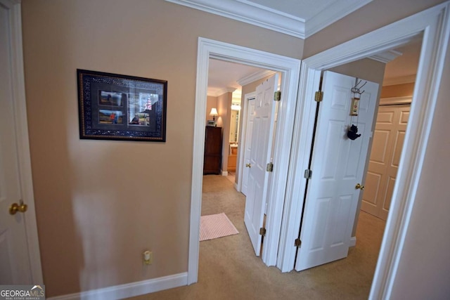 hallway featuring light carpet and crown molding