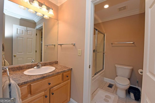 full bathroom with tile patterned floors, ornamental molding, vanity, enclosed tub / shower combo, and toilet