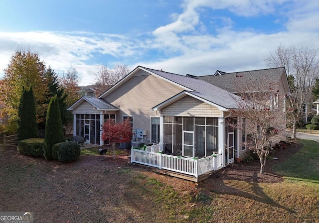 rear view of house with a sunroom