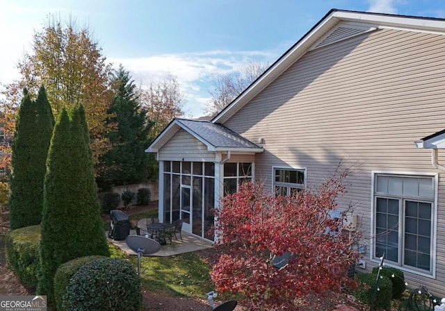 exterior space with a patio area and a sunroom