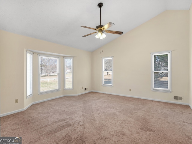 unfurnished room featuring visible vents, light carpet, vaulted ceiling, ceiling fan, and baseboards