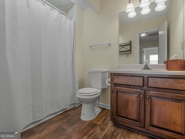 bathroom featuring vanity, wood finished floors, and toilet