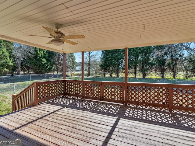 wooden deck featuring ceiling fan and fence