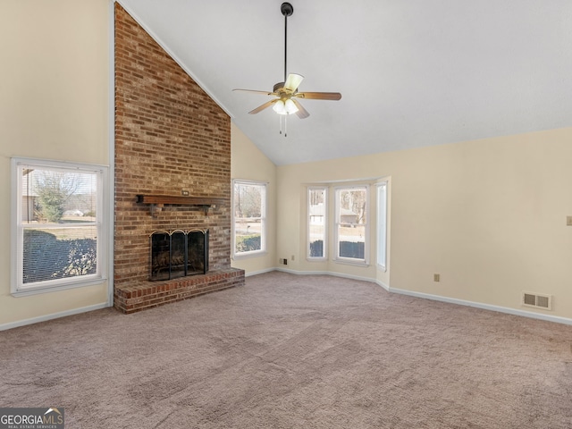 unfurnished living room featuring ceiling fan, a brick fireplace, light colored carpet, and high vaulted ceiling