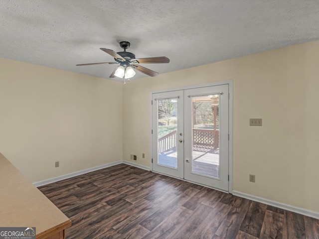 interior space with dark wood-style floors, french doors, a textured ceiling, and baseboards