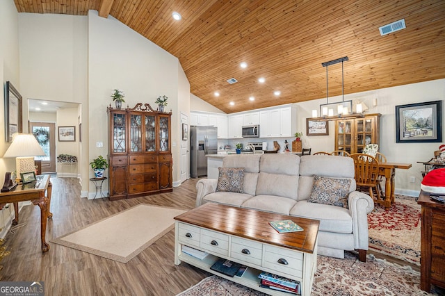 living room with high vaulted ceiling, light hardwood / wood-style floors, and wood ceiling