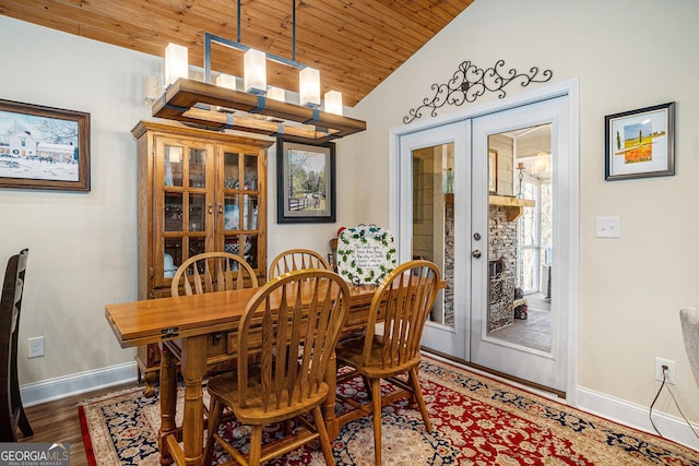 dining room with a notable chandelier, wooden ceiling, french doors, dark hardwood / wood-style floors, and lofted ceiling