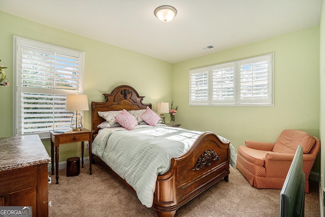 carpeted bedroom featuring multiple windows