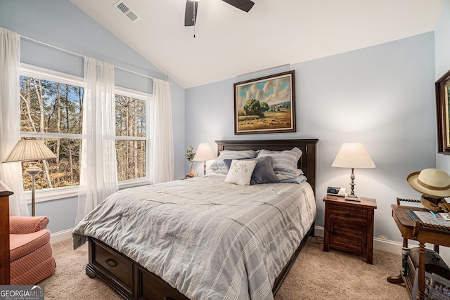 carpeted bedroom featuring ceiling fan, multiple windows, and lofted ceiling