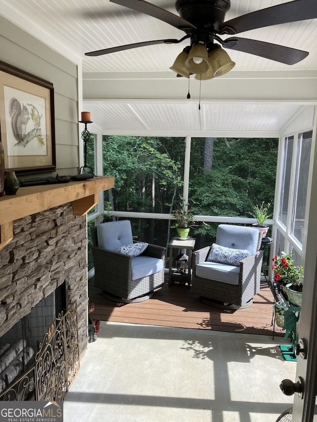 exterior space with ceiling fan and an outdoor stone fireplace