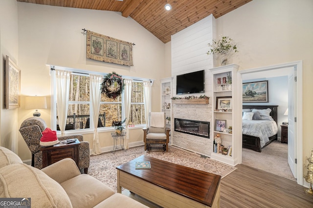 living room featuring a stone fireplace, hardwood / wood-style floors, wood ceiling, high vaulted ceiling, and beam ceiling