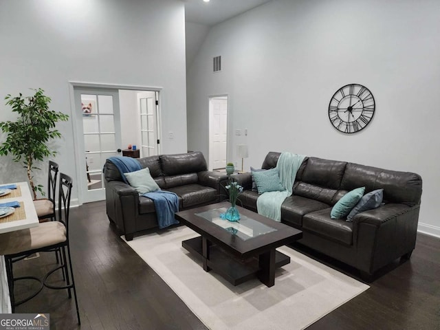 living room featuring hardwood / wood-style flooring and high vaulted ceiling