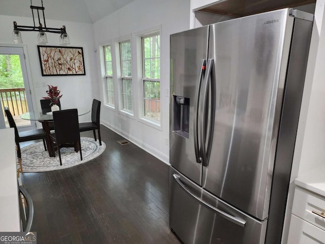 kitchen with hardwood / wood-style floors, white cabinets, stainless steel refrigerator with ice dispenser, and a wealth of natural light