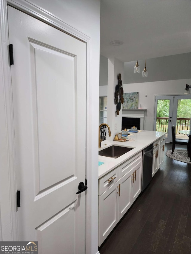 kitchen featuring french doors, sink, black dishwasher, dark hardwood / wood-style floors, and white cabinetry