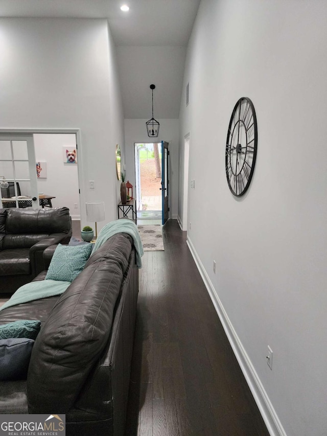 interior space featuring dark hardwood / wood-style flooring and high vaulted ceiling