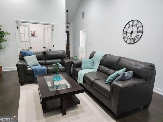 living room with high vaulted ceiling and french doors