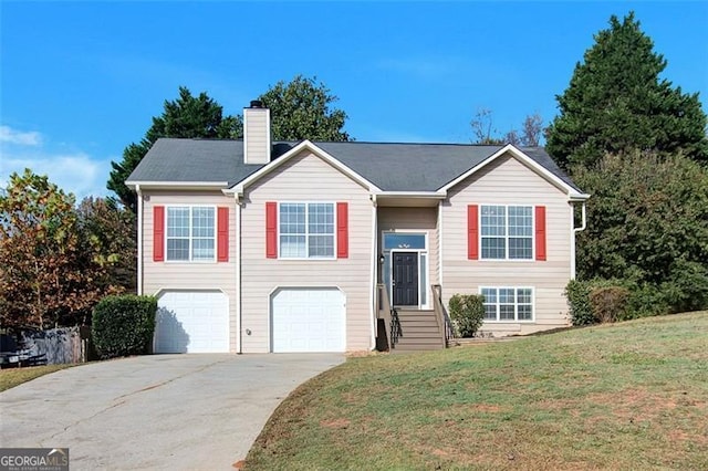 bi-level home with a front lawn and a garage