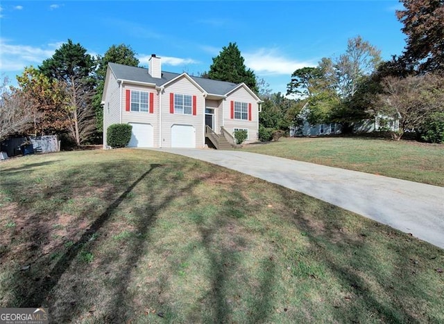 split foyer home with a garage and a front lawn