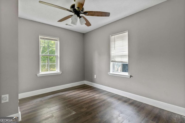 spare room with dark hardwood / wood-style floors and ceiling fan