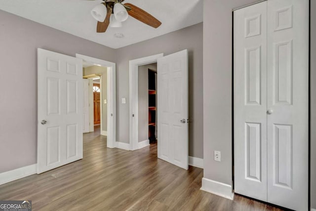 unfurnished bedroom featuring hardwood / wood-style flooring and ceiling fan