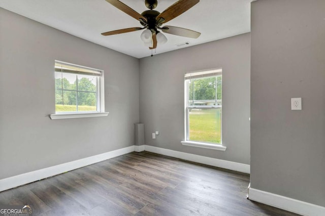 unfurnished room featuring ceiling fan and dark wood-type flooring