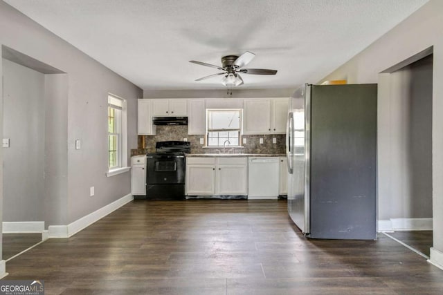 kitchen with electric range, stainless steel fridge, white cabinetry, and white dishwasher