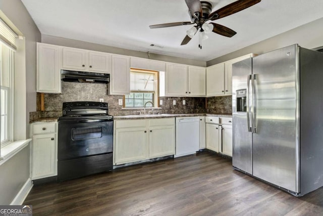 kitchen with stainless steel fridge, white dishwasher, sink, black electric range, and dark hardwood / wood-style floors