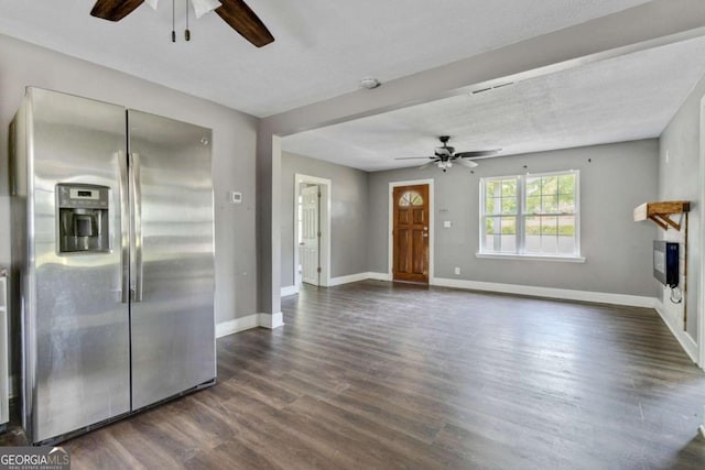 unfurnished living room featuring ceiling fan, dark wood-type flooring, and a textured ceiling