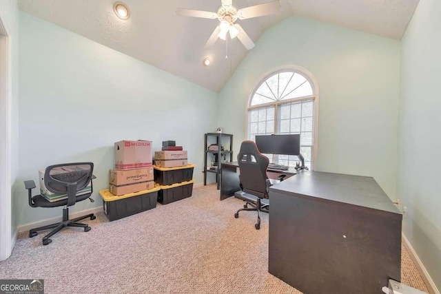 office featuring ceiling fan, vaulted ceiling, and light carpet