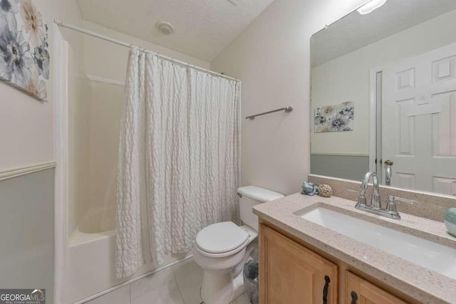 full bathroom with tile patterned flooring, vanity, shower / tub combo, and toilet