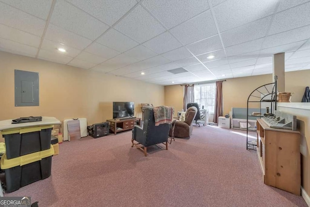 carpeted living room featuring a paneled ceiling and electric panel