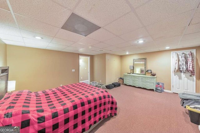 carpeted bedroom featuring a paneled ceiling