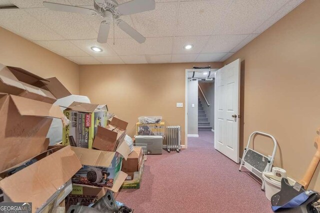 misc room featuring carpet floors, ceiling fan, and a paneled ceiling