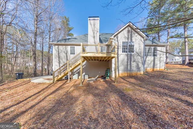 rear view of property featuring a deck