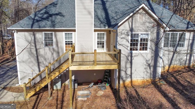 rear view of property with central AC unit and a deck