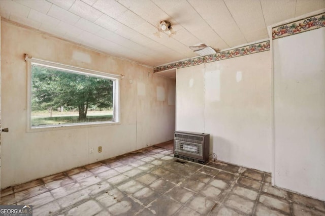 empty room featuring heating unit and a wood stove