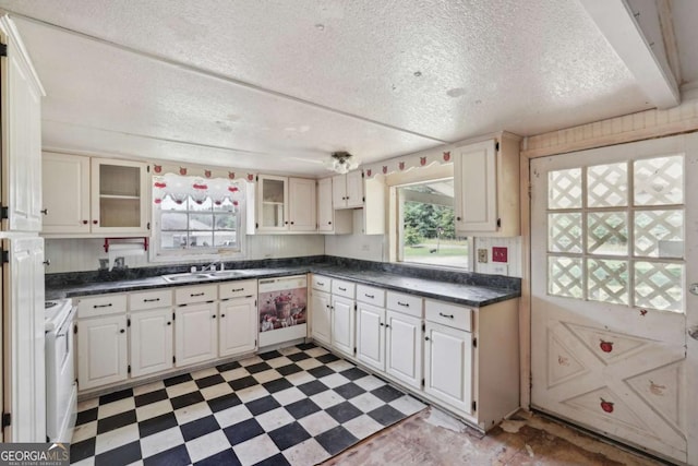 kitchen featuring a textured ceiling, white appliances, and white cabinetry