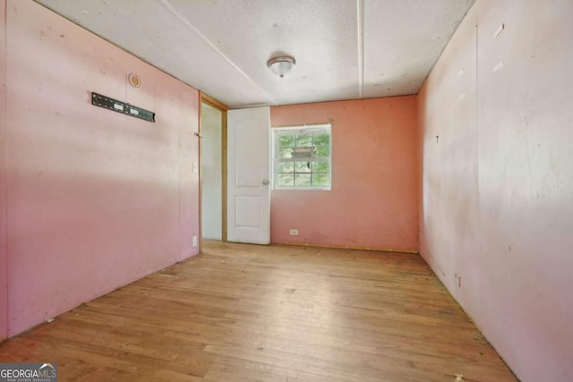 spare room with light wood-type flooring