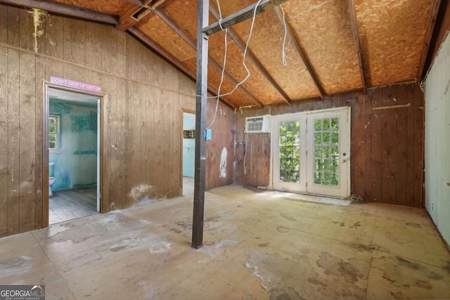 miscellaneous room featuring an AC wall unit and vaulted ceiling