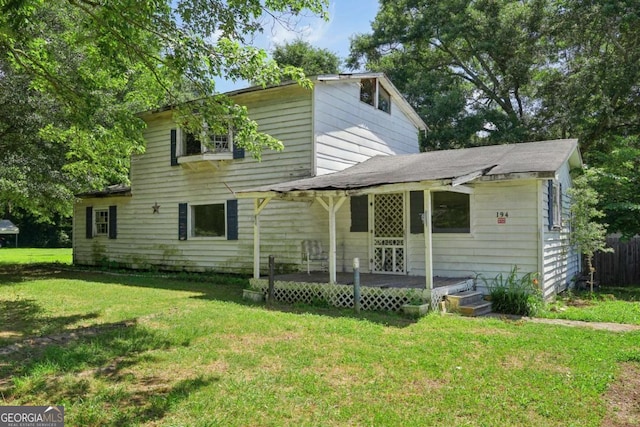 back of house with a wooden deck and a yard