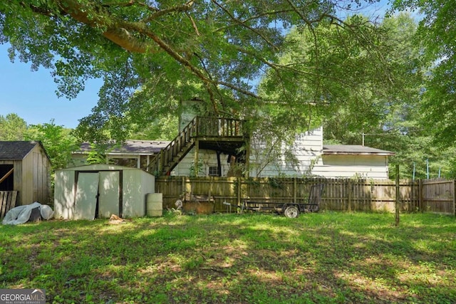 view of yard with a deck and a storage shed