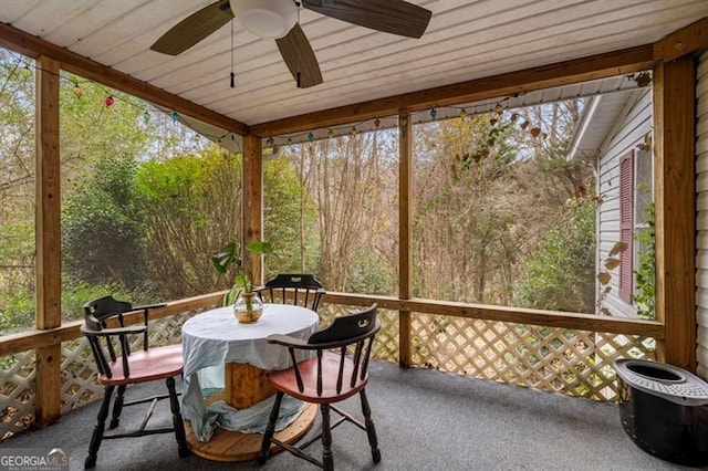 sunroom / solarium with plenty of natural light, wooden ceiling, and ceiling fan