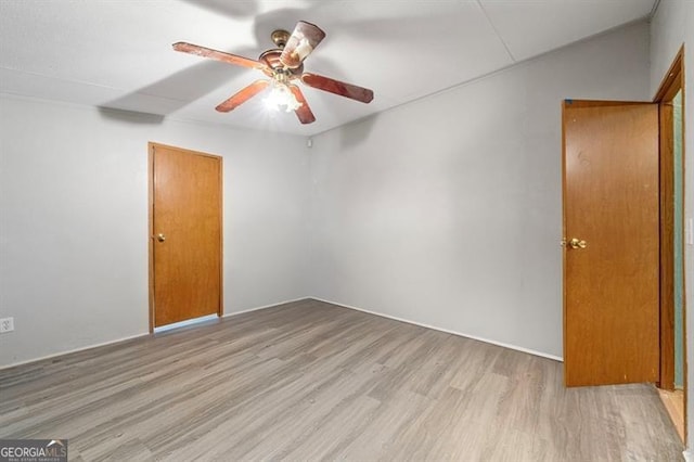 spare room with ceiling fan and light hardwood / wood-style flooring