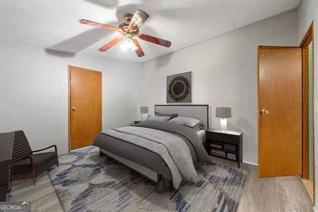 bedroom with hardwood / wood-style flooring and ceiling fan