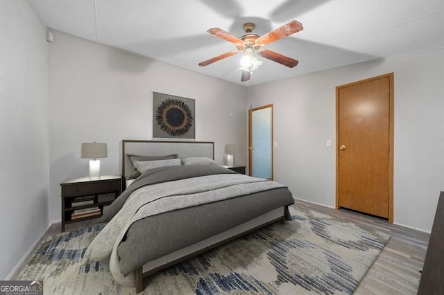 bedroom with hardwood / wood-style flooring and ceiling fan