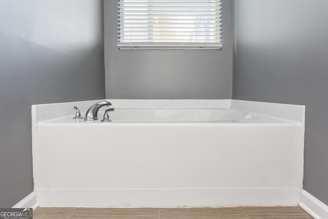 bathroom with a tub to relax in