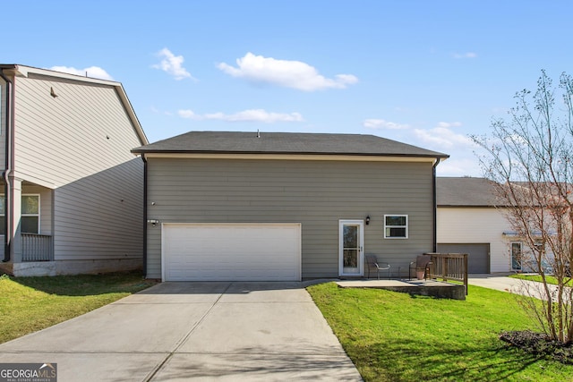 view of front of house featuring a front lawn, a patio, and a garage