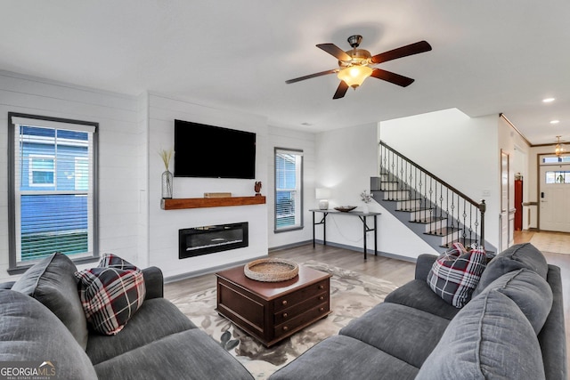 living room featuring ceiling fan and light wood-type flooring