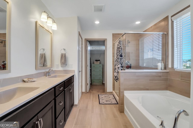 bathroom featuring separate shower and tub, a wealth of natural light, tile patterned flooring, and vanity