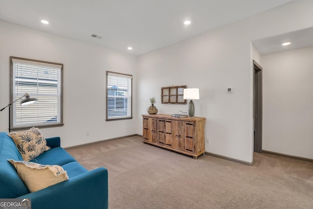 living area with light carpet